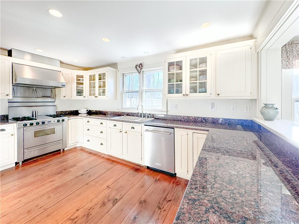 414 Riverside Avenue Westport, CT 06880 - Photo 6 of 40 a kitchen with granite countertop a stove and white cabinets