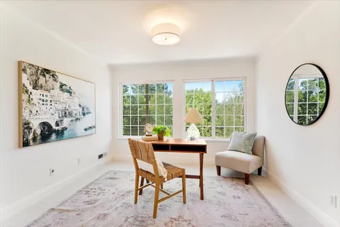a dining room with furniture and a window