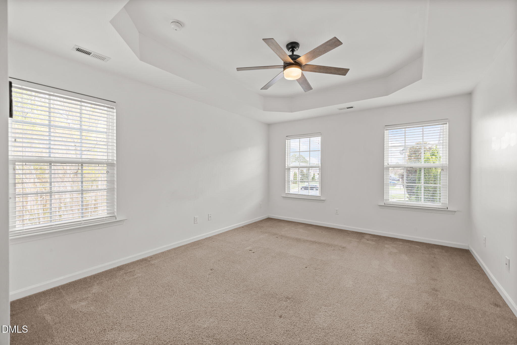 401 Stone Flower Lane Raleigh, NC 27603 - Photo 11 of 28 an empty room with windows and fan