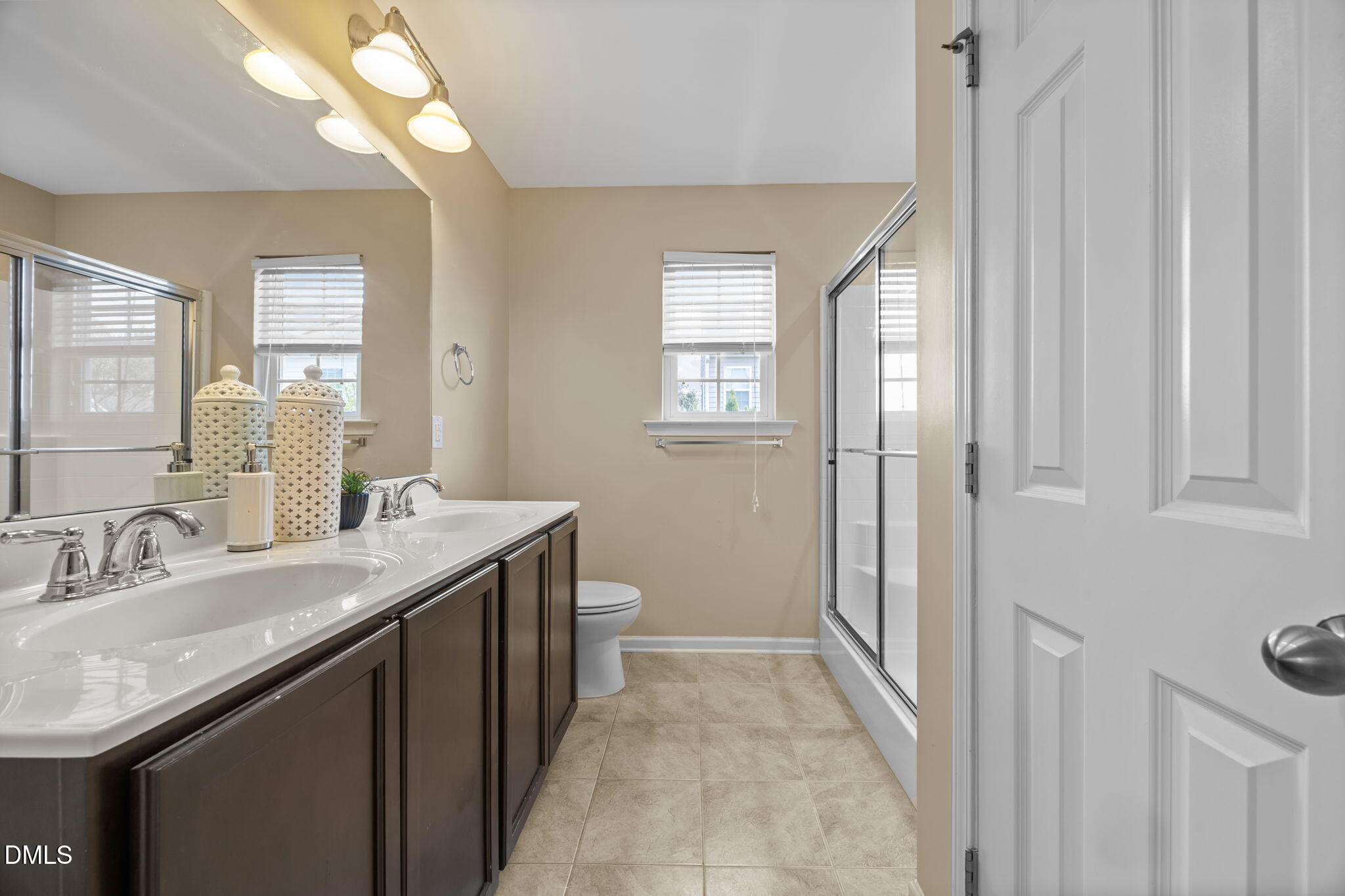 401 Stone Flower Lane Raleigh, NC 27603 - Photo 12 of 28 a spacious bathroom with a granite countertop sink and a mirror