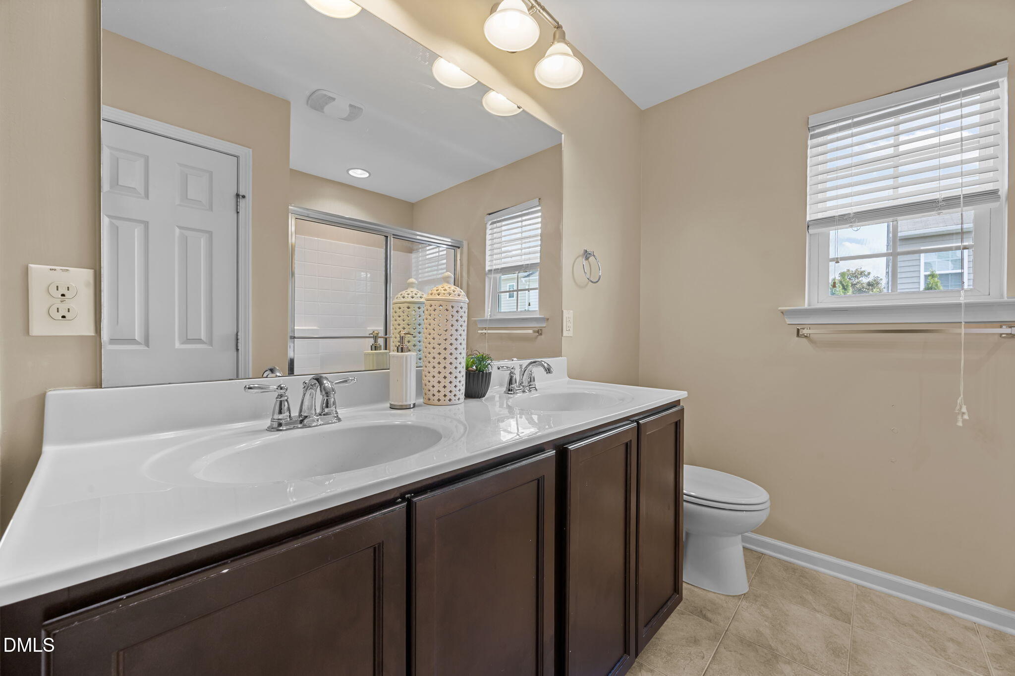 401 Stone Flower Lane Raleigh, NC 27603 - Photo 13 of 28 a bathroom with a granite countertop sink a toilet and a mirror