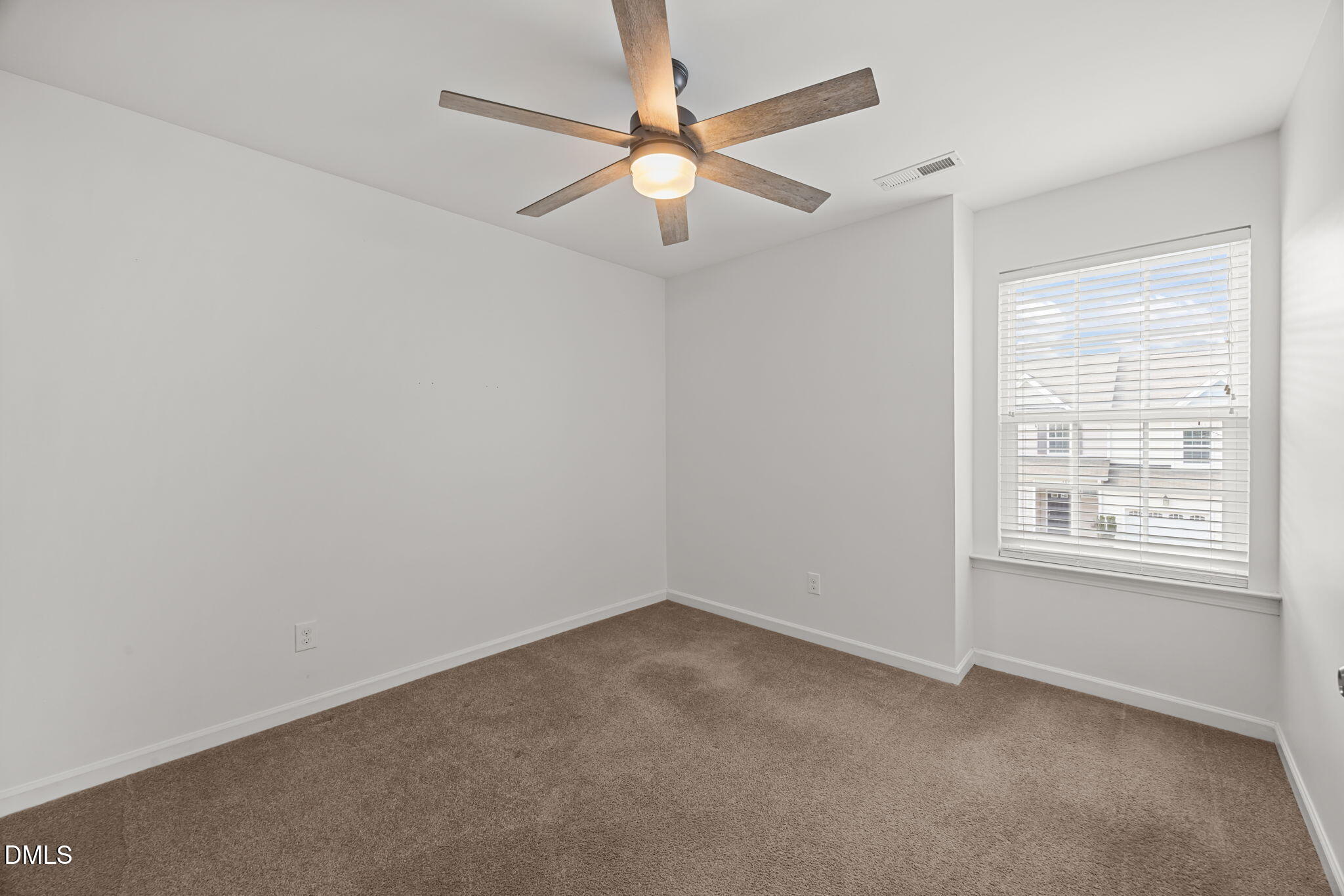 401 Stone Flower Lane Raleigh, NC 27603 - Photo 15 of 28 an empty room with a window and a fan