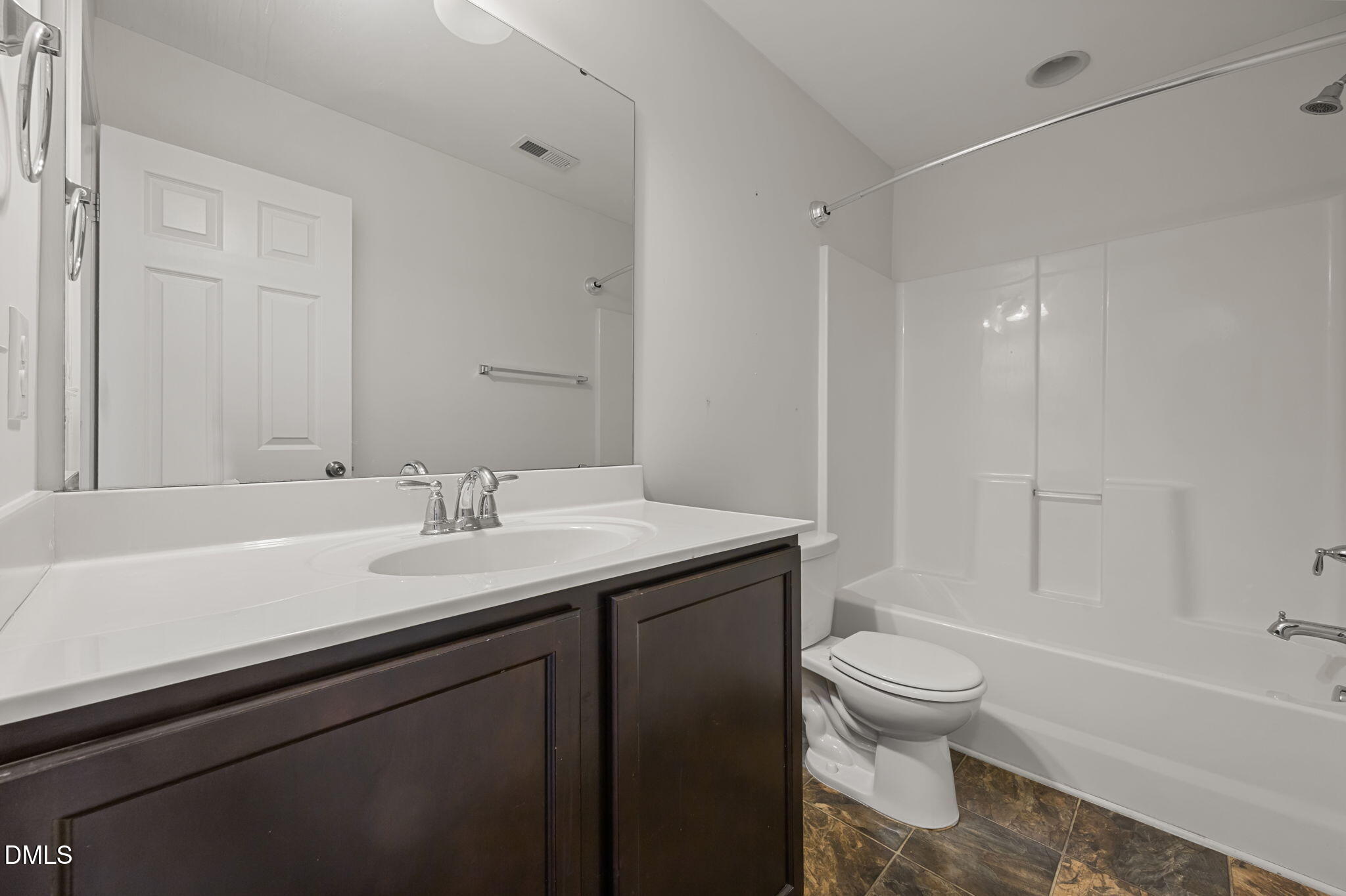 401 Stone Flower Lane Raleigh, NC 27603 - Photo 17 of 28 a bathroom with a sink a toilet and shower