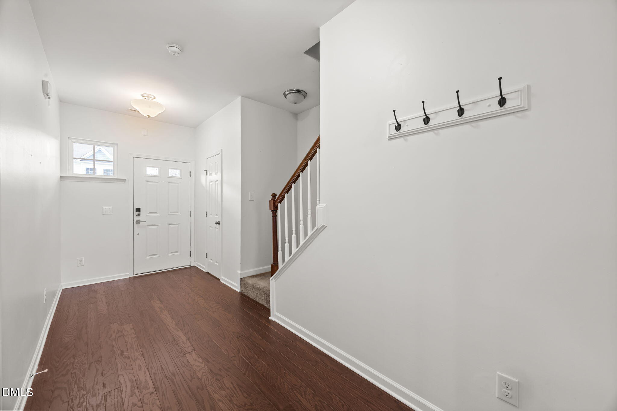 401 Stone Flower Lane Raleigh, NC 27603 - Photo 4 of 28 a view of a hallway with wooden floor and staircase
