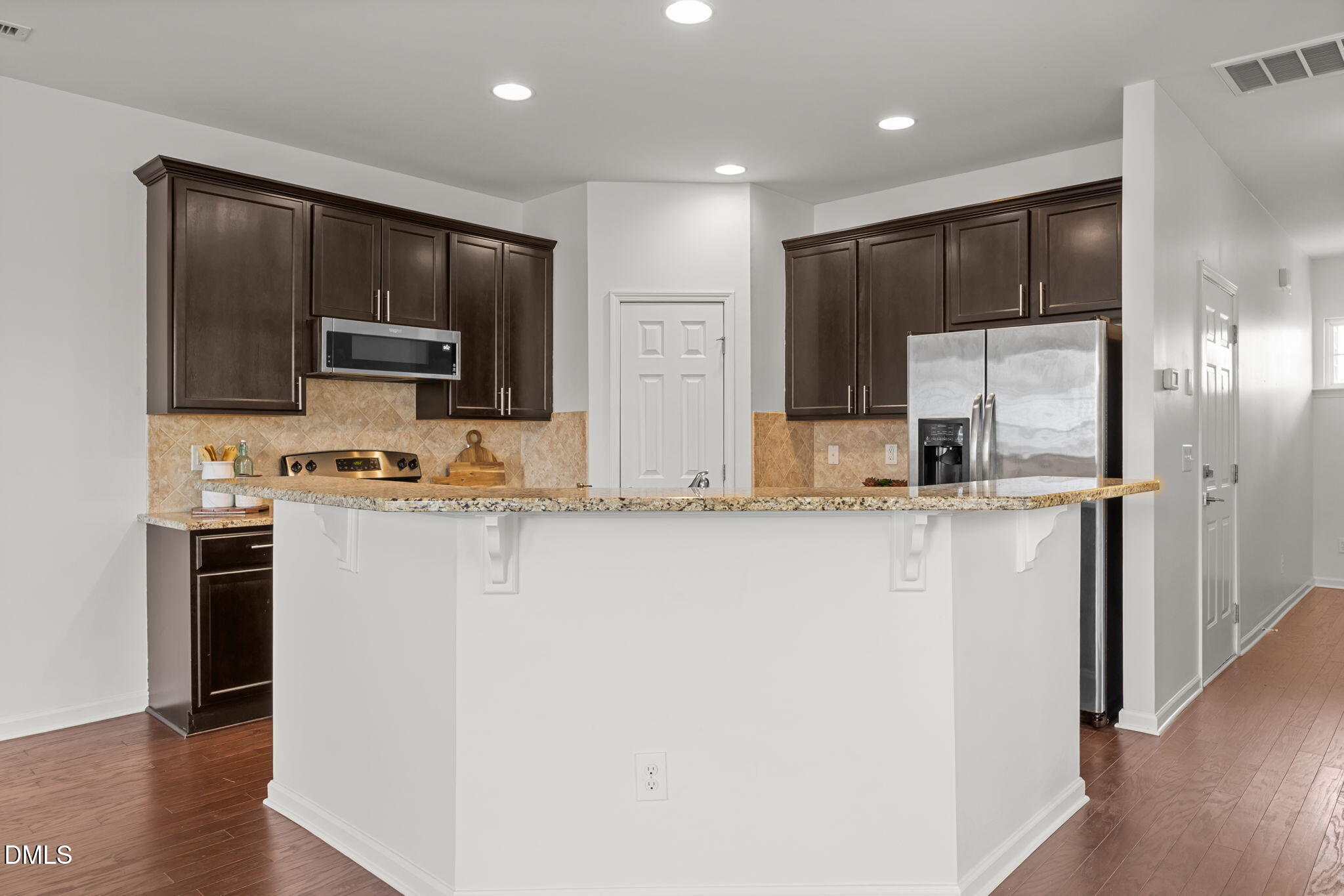 401 Stone Flower Lane Raleigh, NC 27603 - Photo 5 of 28 a kitchen with stainless steel appliances a refrigerator stove microwave and sink
