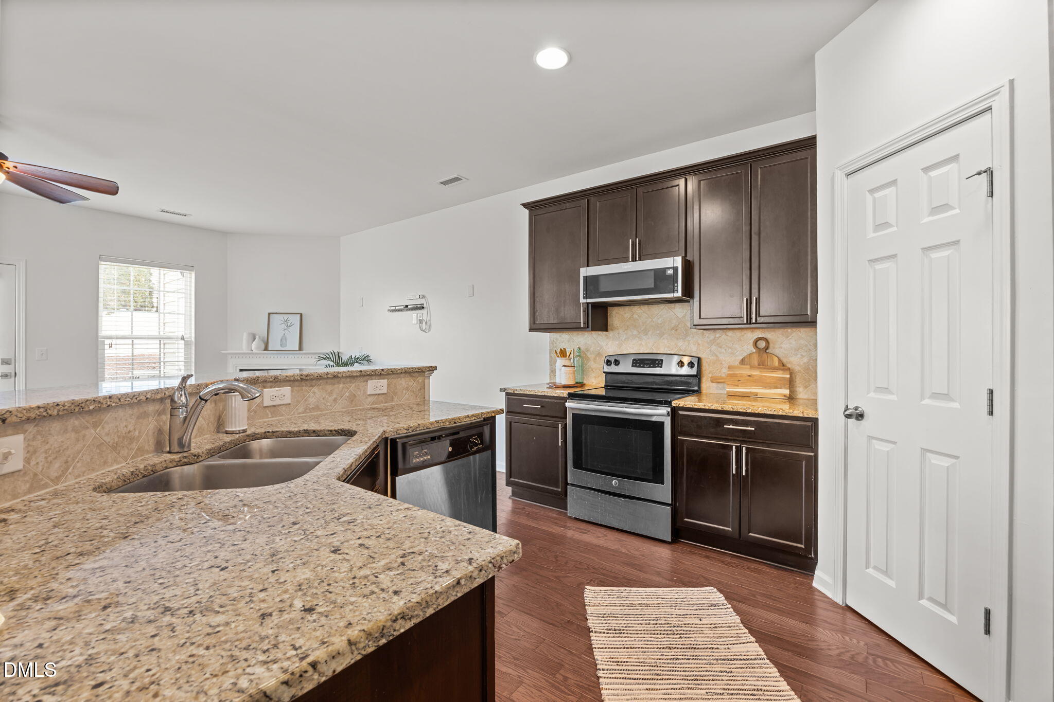 401 Stone Flower Lane Raleigh, NC 27603 - Photo 6 of 28 a kitchen with stainless steel appliances granite countertop a sink stove and refrigerator