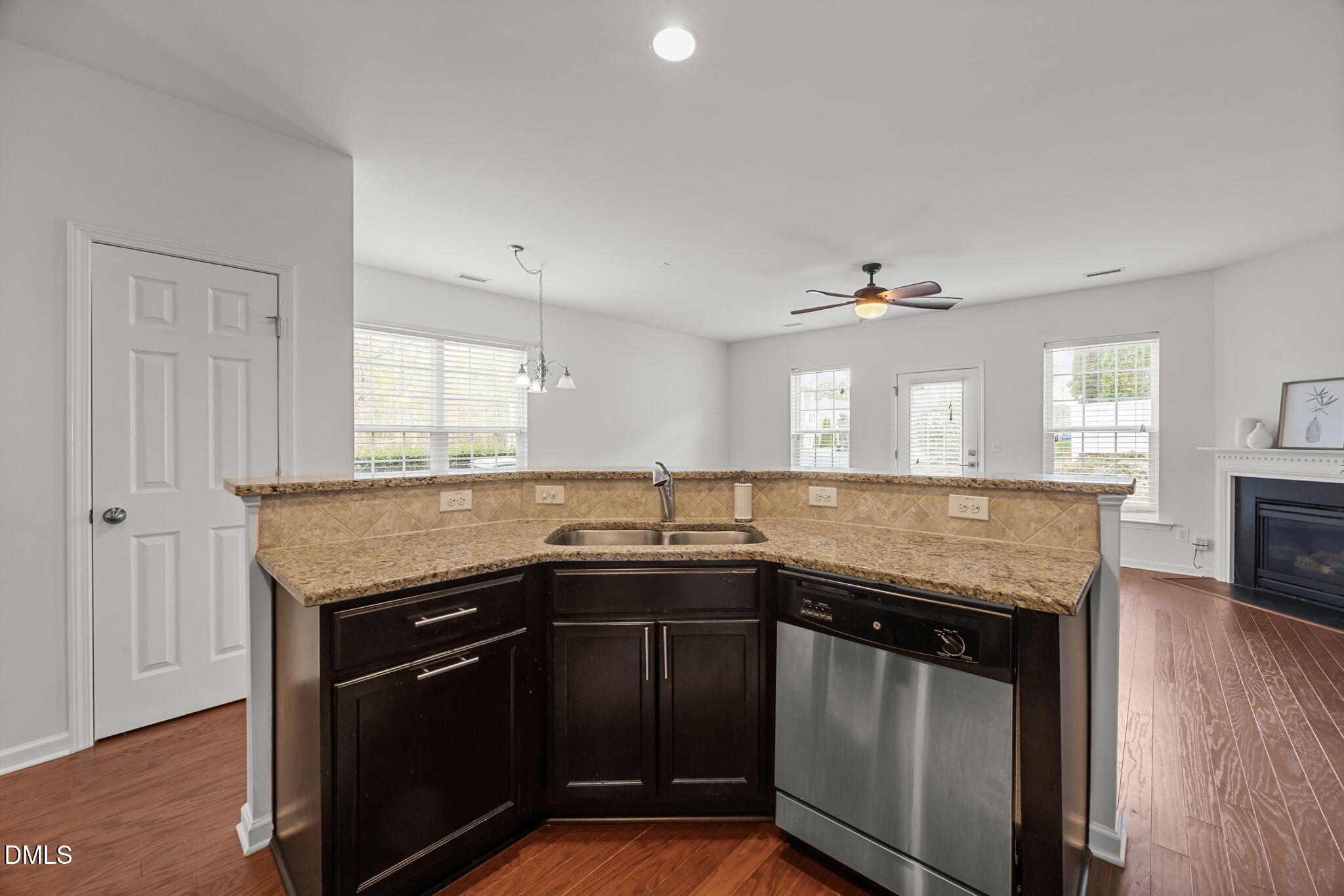 401 Stone Flower Lane Raleigh, NC 27603 - Photo 7 of 28 a kitchen with granite countertop a sink and cabinets