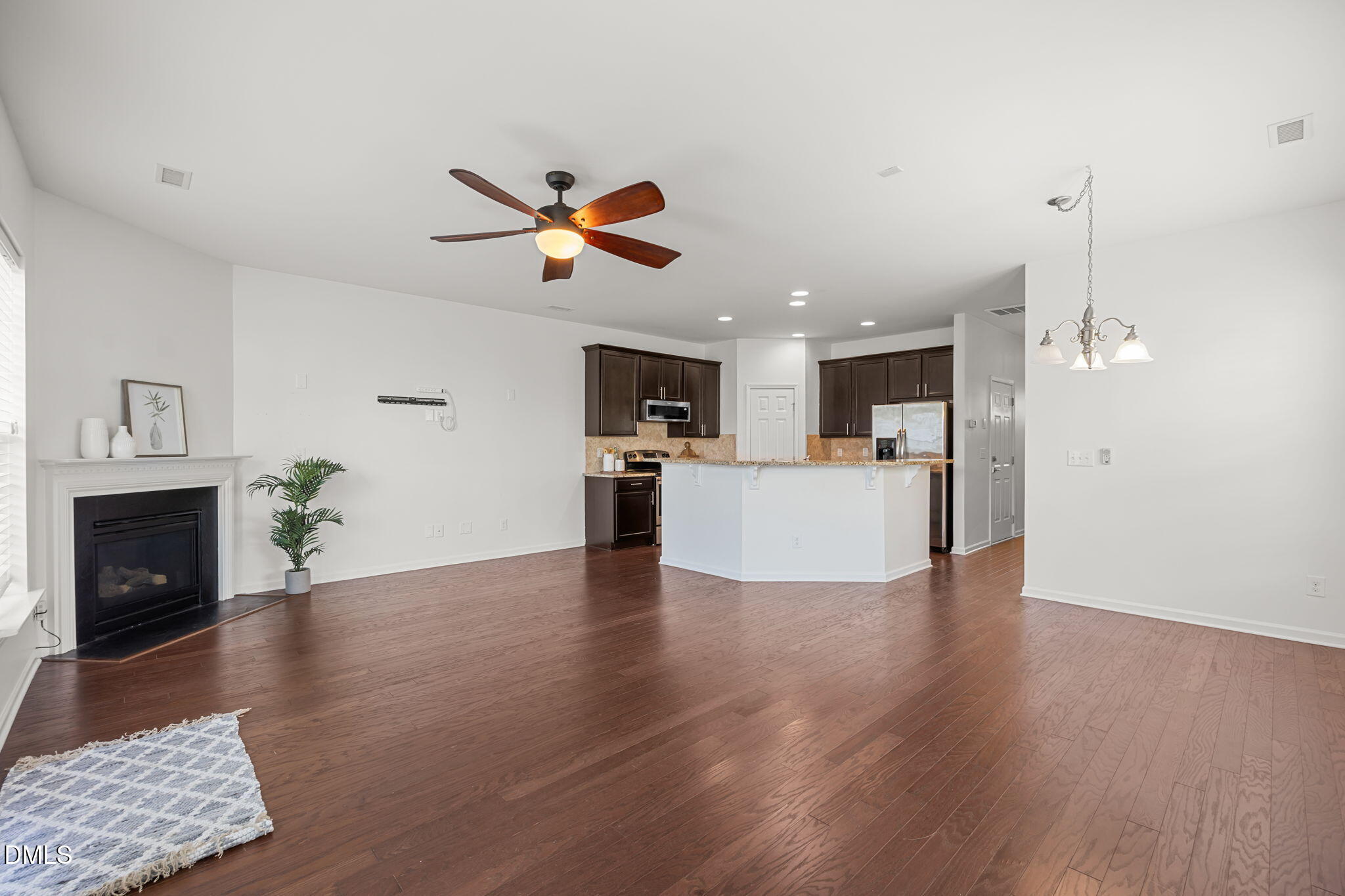 401 Stone Flower Lane Raleigh, NC 27603 - Photo 9 of 28 a view of a kitchen with a fireplace a sink and a fireplace