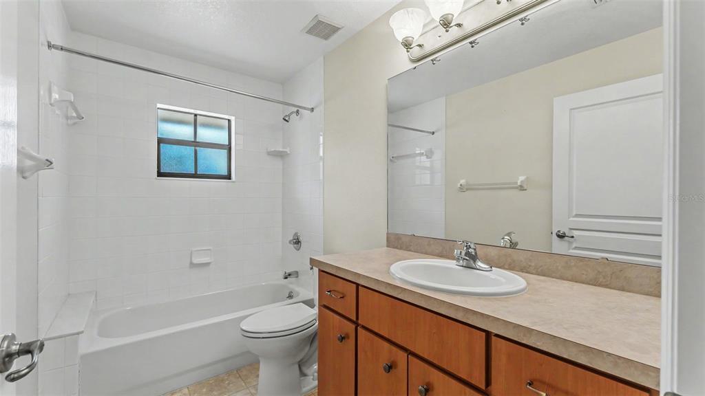 8525 North Campbell Road Lakeland, FL 33810 - Photo 14 of 45 a bathroom with a sink a toilet and shower