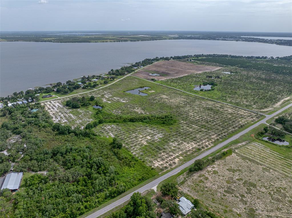 0 Barr Road Frostproof, FL 33843 - Photo 6 of 11 a view of a lake from a yard