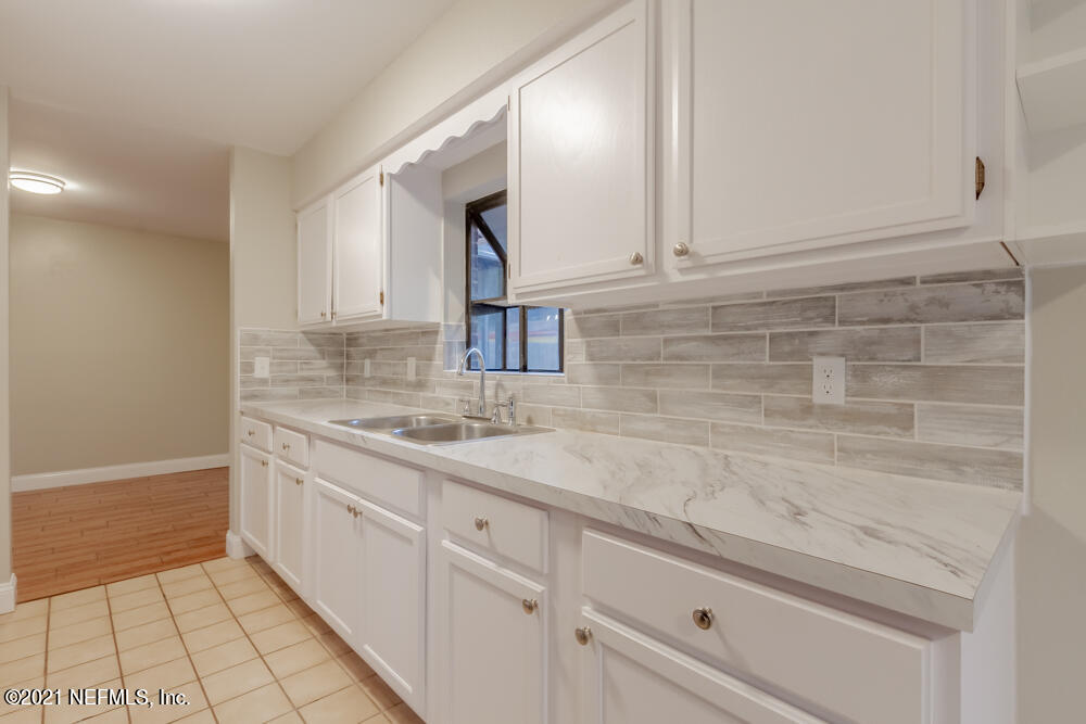 7447 Wheat Road Jacksonville, FL 32244 - Photo 11 of 42 a bathroom with a sink and a mirror