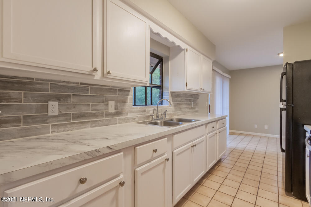 7447 Wheat Road Jacksonville, FL 32244 - Photo 14 of 42 a kitchen with a sink and cabinets