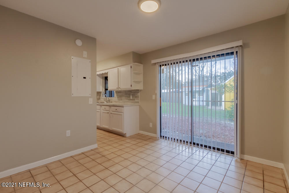 7447 Wheat Road Jacksonville, FL 32244 - Photo 16 of 42 a view of a kitchen with a sink and an empty room