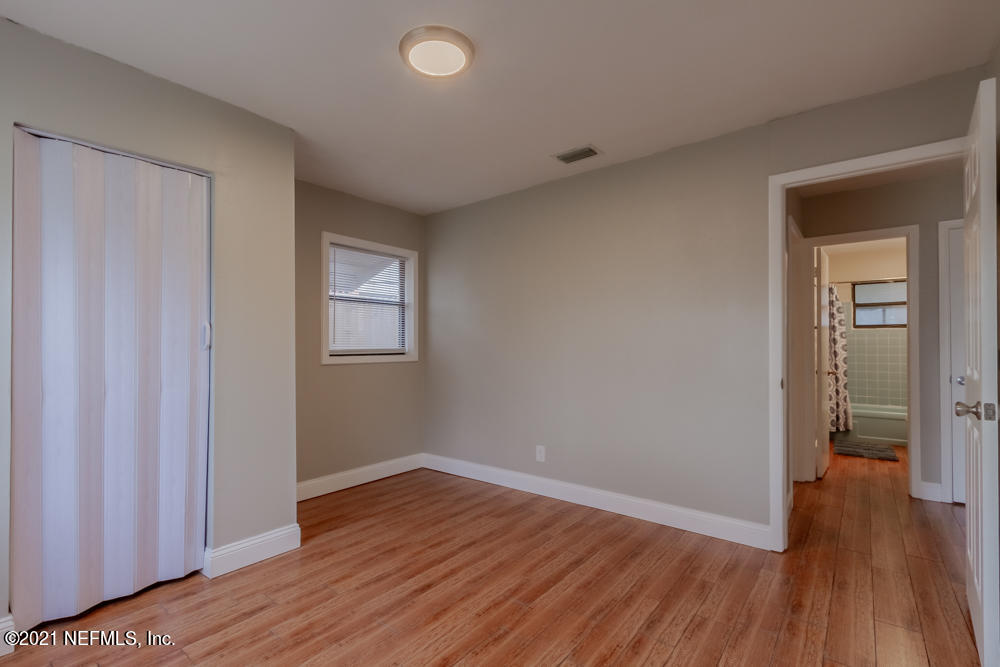 7447 Wheat Road Jacksonville, FL 32244 - Photo 23 of 42 wooden floor in an empty room with a window