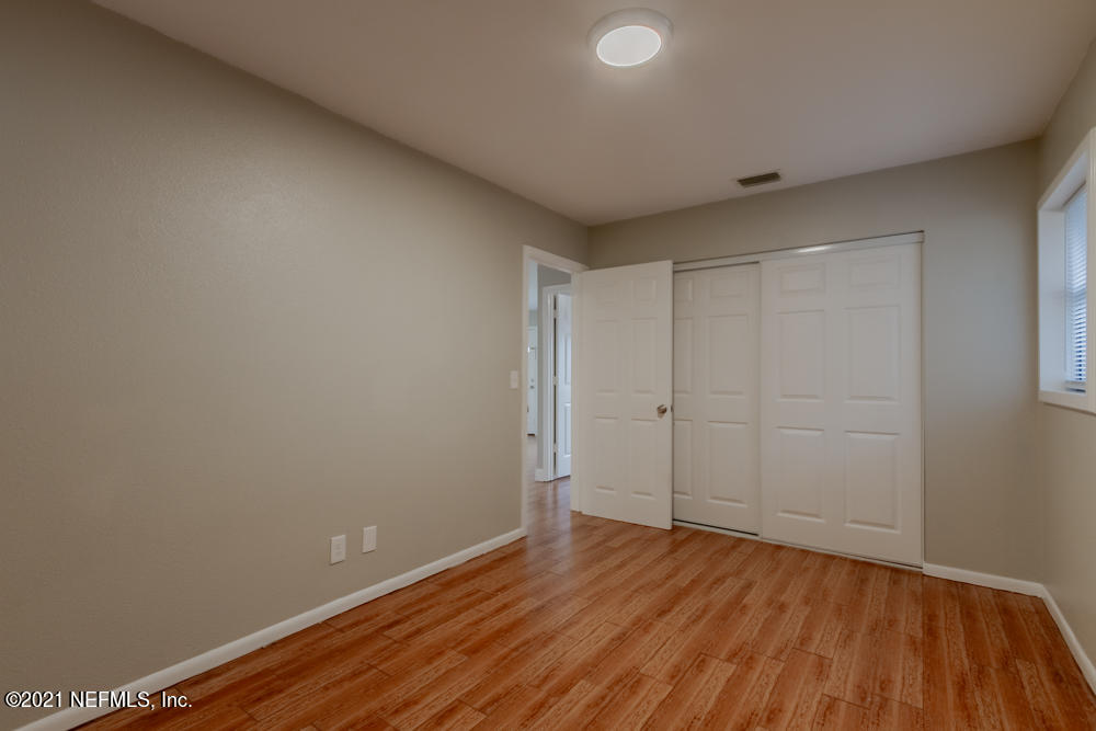 7447 Wheat Road Jacksonville, FL 32244 - Photo 26 of 42 a view of an empty room and wooden floor