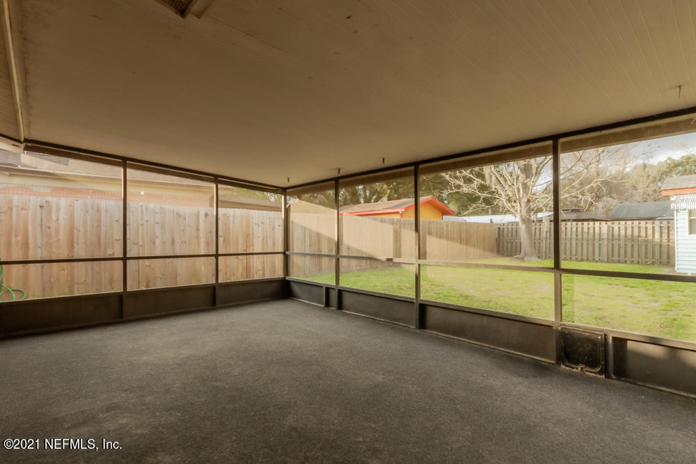 7447 Wheat Road Jacksonville, FL 32244 - Photo 40 of 42 a view of an empty room with sliding door