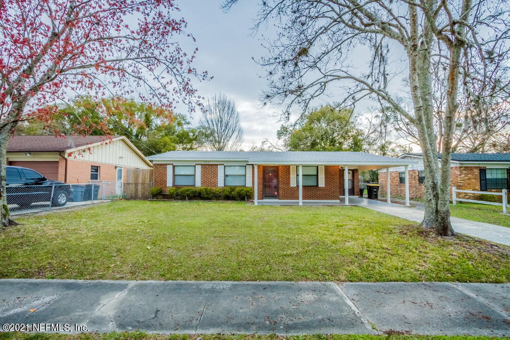 7447 Wheat Road Jacksonville, FL 32244 - Photo 5 of 42 a front view of a house with a garden