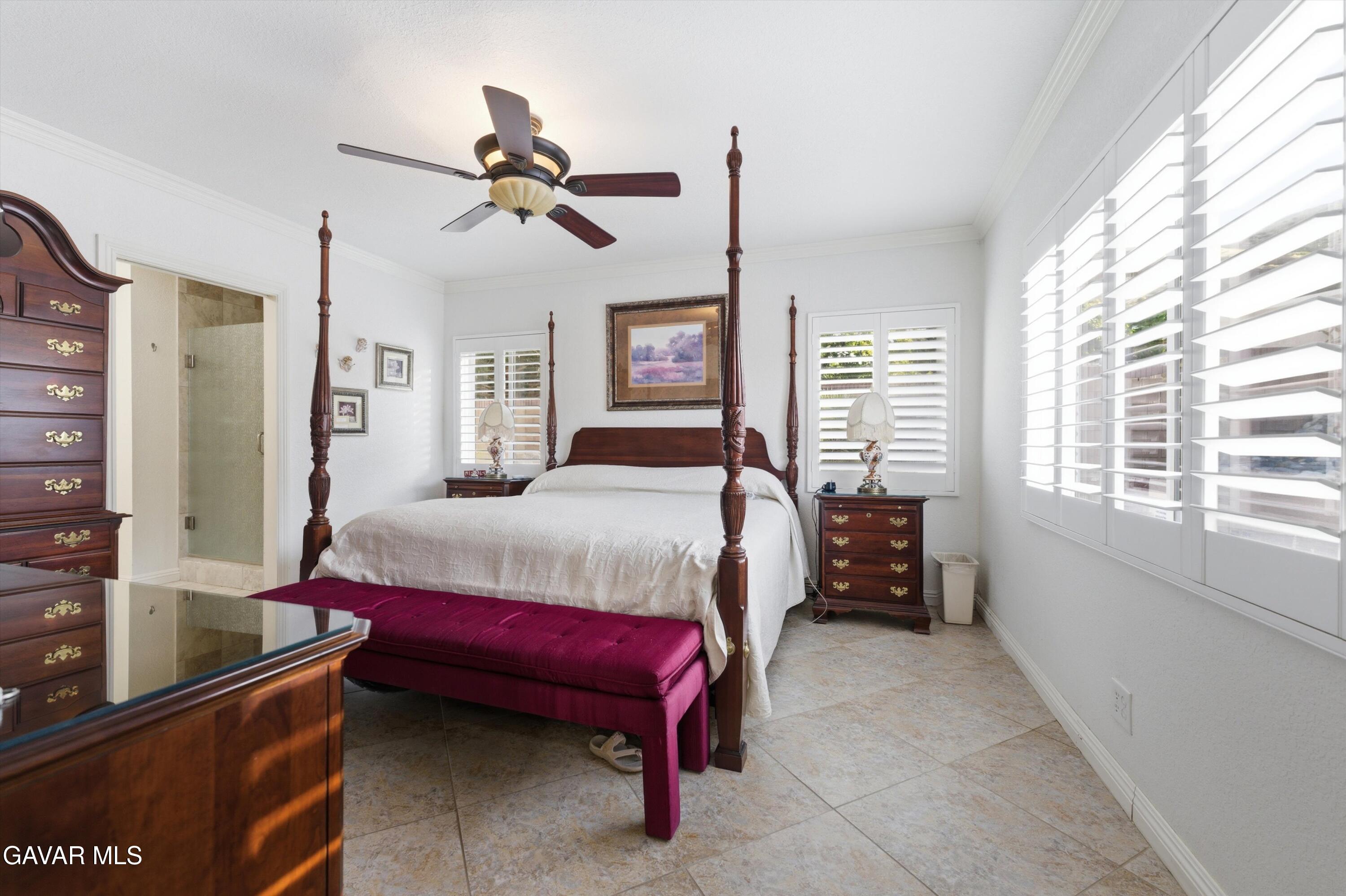 5801 Hacienda Ranch Road Palmdale, CA 93551 - Photo 31 of 69 a bedroom with a bed and a chandelier