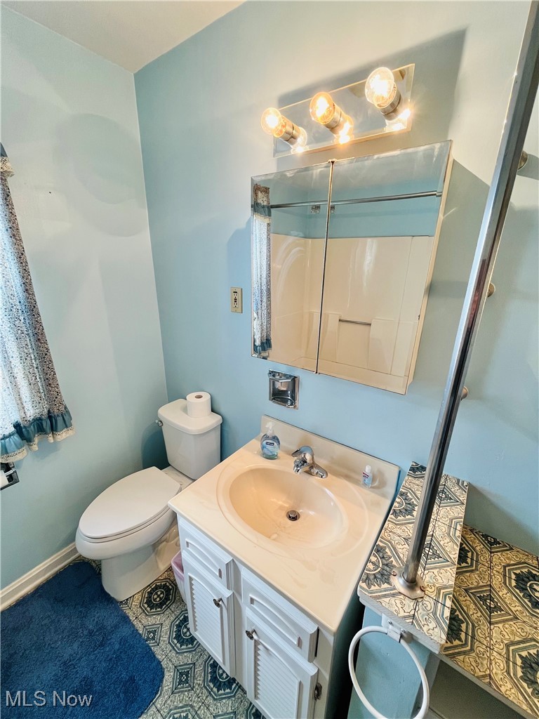3210 Austinburg Road Ashtabula, OH 44004 - Photo 6 of 48 Bathroom with toilet, tile patterned floors, and vanity