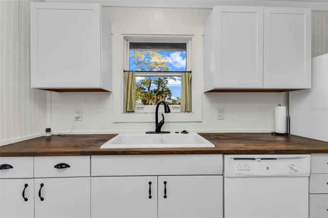a bathroom with a sink toilet a mirror and shower