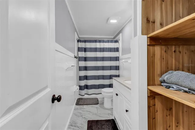 a view of a big room with wooden floor closet and windows