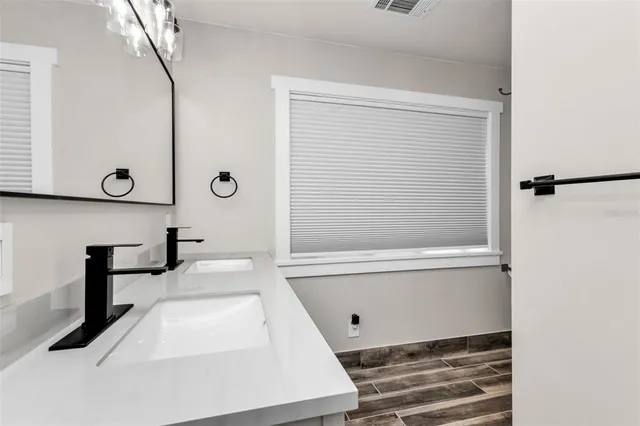 a view of a house with a yard and large trees