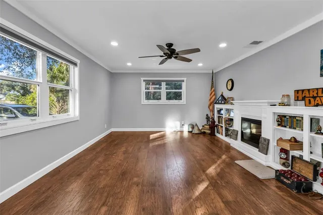 a view of a livingroom with furniture hardwood floor and workspace