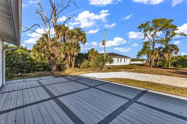 a view of a house with a tree in the yard