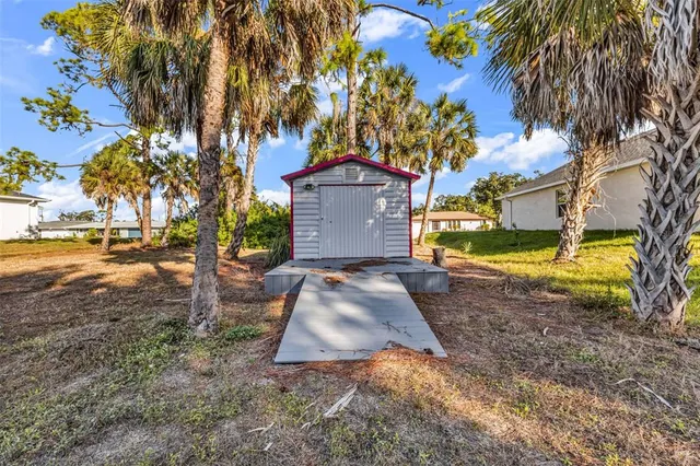 an aerial view of residential houses with outdoor space and trees
