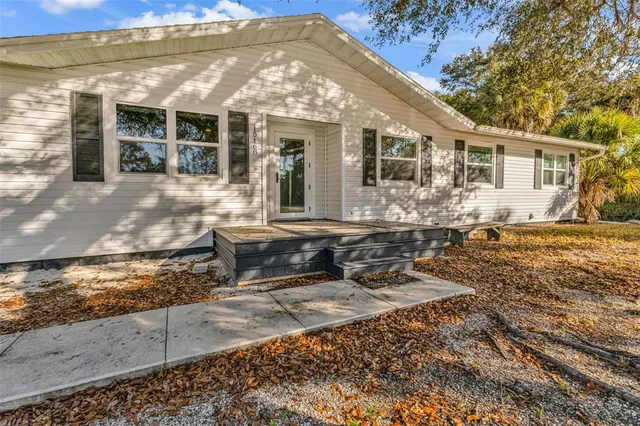 an aerial view of residential houses with city and green space