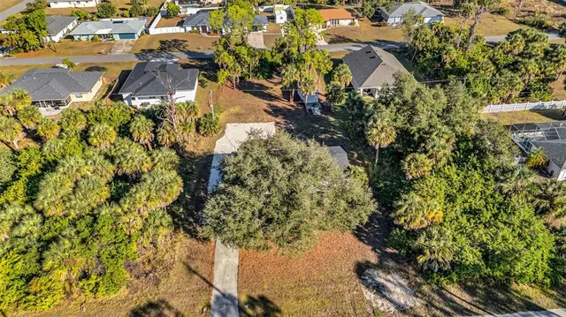 a aerial view of a house with a yard and garden