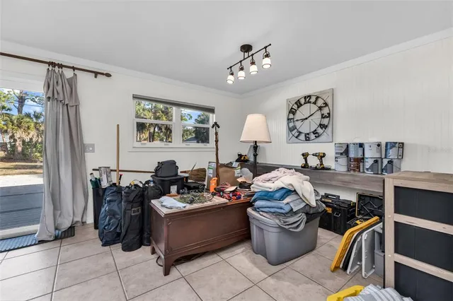 a living room with furniture a chandelier and a window