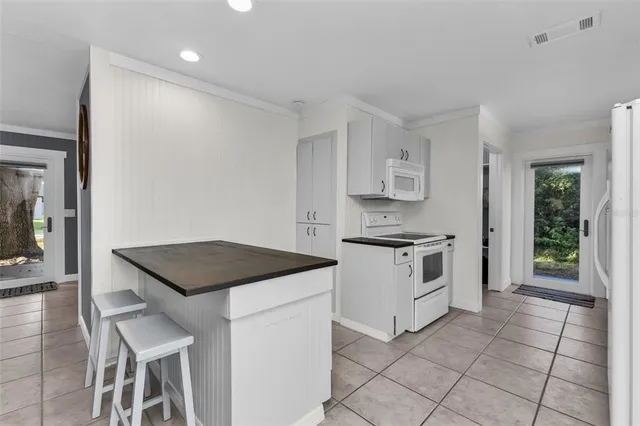 a kitchen with a stove a sink and a refrigerator