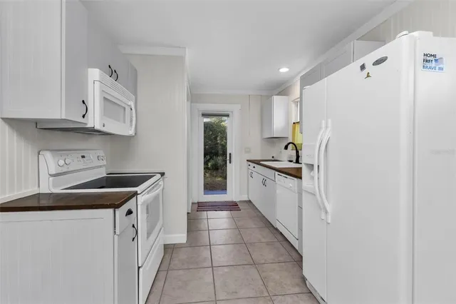 a kitchen with stainless steel appliances granite countertop a sink and a refrigerator