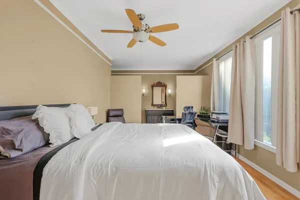 a bed room with a bed and a large window