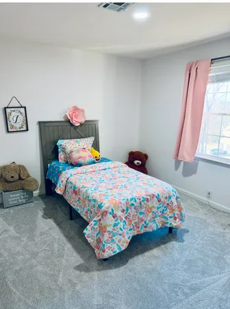 a bedroom with bed and a window