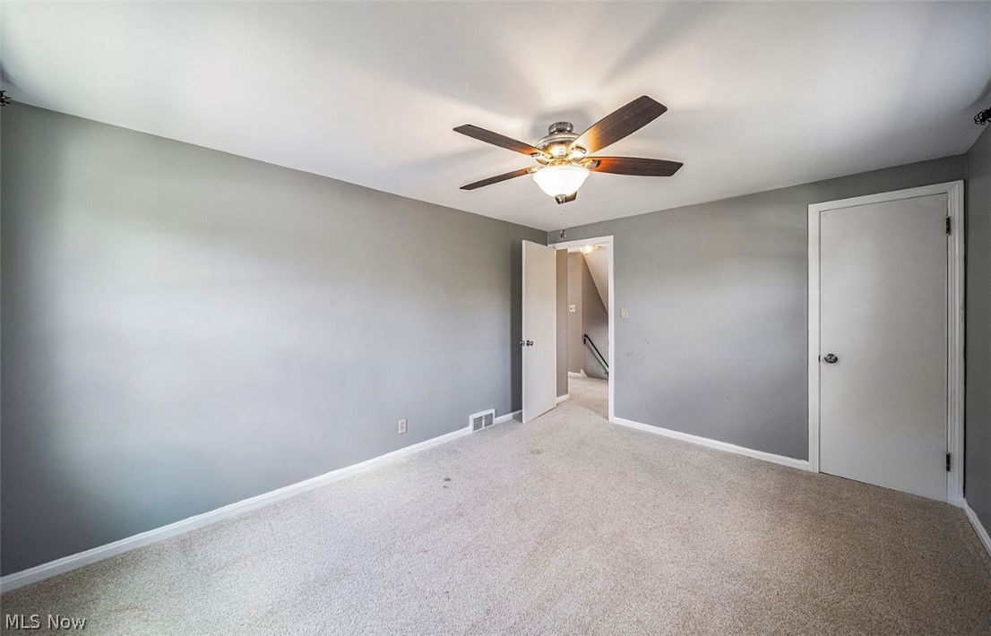 4069 Bushnell Road Cleveland, OH 44121 - Photo 21 of 39 Unfurnished bedroom with carpet and ceiling fan