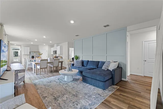 a living room with lots of furniture and white walls