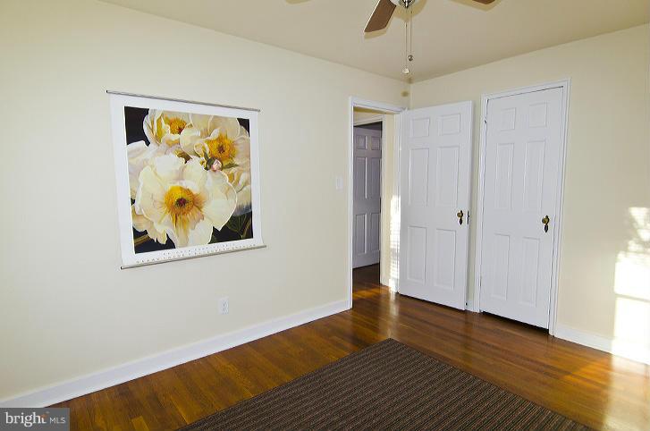 211 East Glebe Road, Unit B Alexandria, VA 22305 - Photo 13 of 15 a view of an empty room with wooden floor and a window