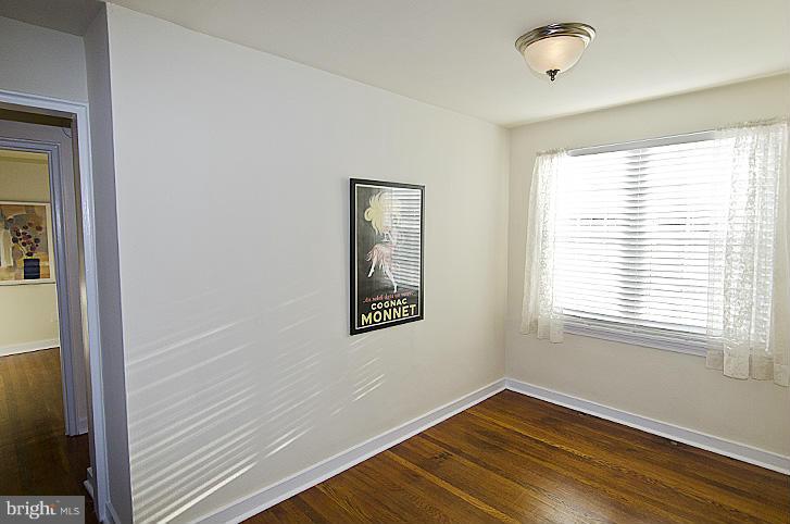 211 East Glebe Road, Unit B Alexandria, VA 22305 - Photo 5 of 15 a view of an empty room with wooden floor and a window