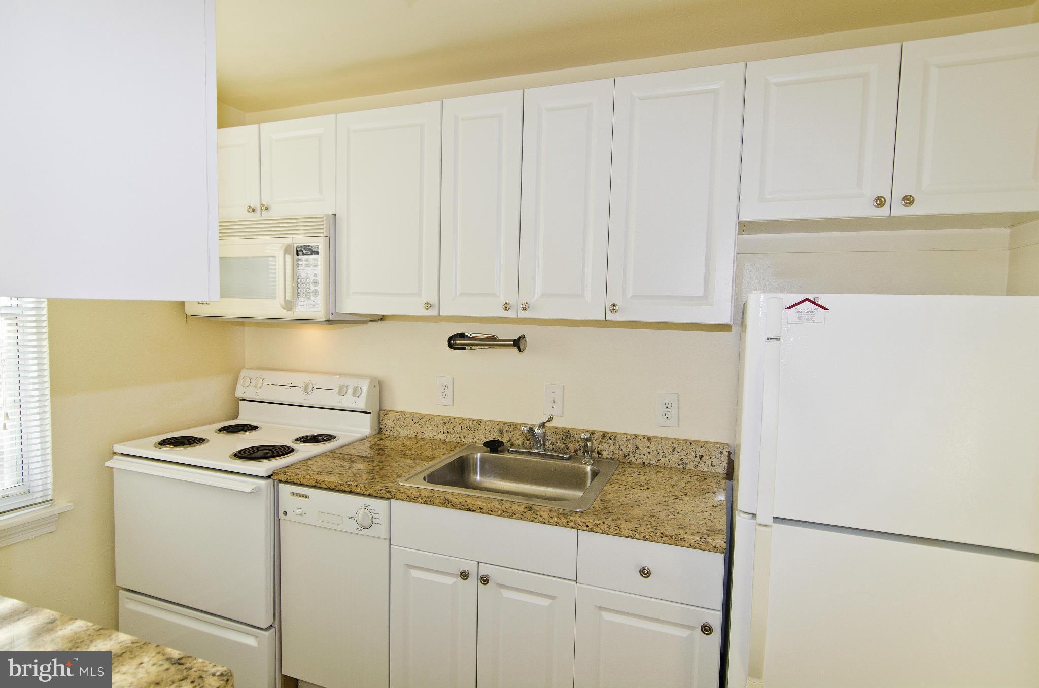 211 East Glebe Road, Unit B Alexandria, VA 22305 - Photo 8 of 15 a kitchen with granite countertop white cabinets and white appliances