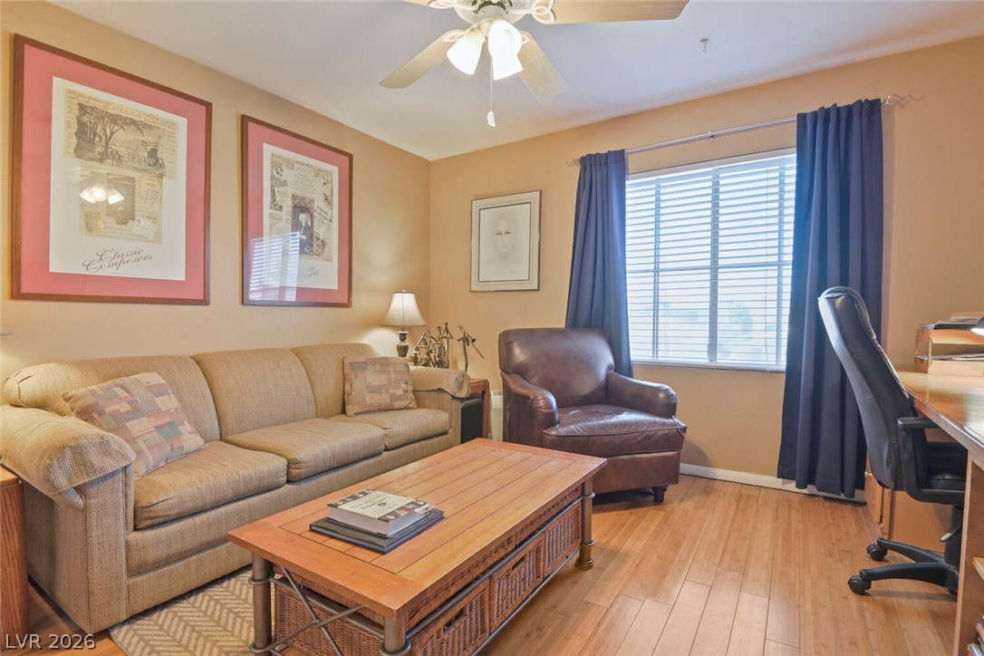 2356 Tilden Way Henderson, NV 89074 - Photo 22 of 30 Hardwood floors and ample natural light define this cozy living space, perfect for relaxation or a home office.