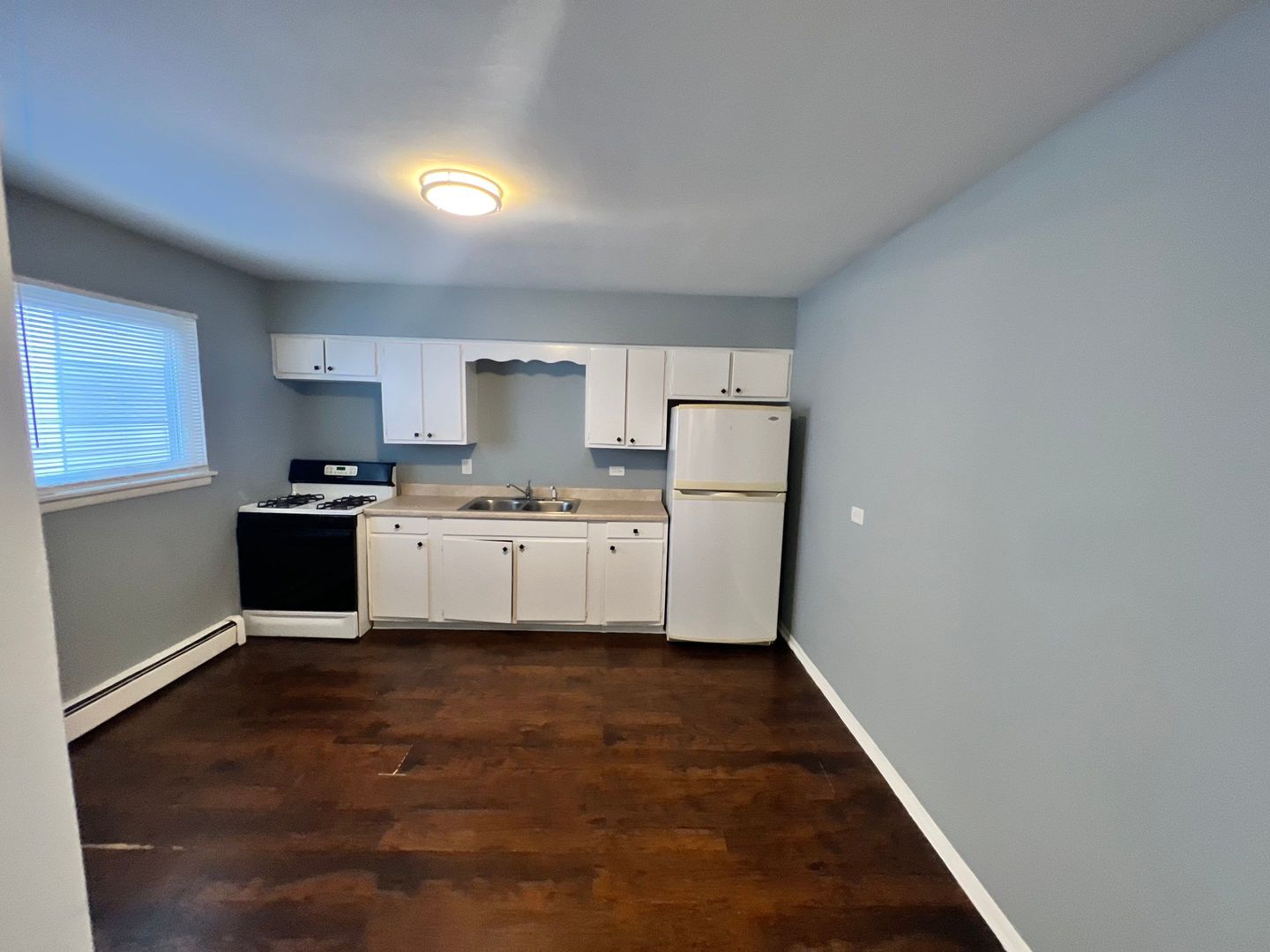 2657 West 47th Street, Unit 6 Chicago, IL 60632 - Photo 13 of 18 a kitchen with white cabinets and white appliances