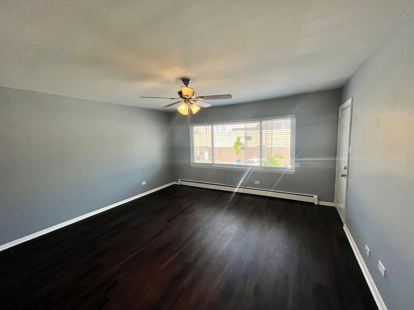 2657 West 47th Street, Unit 6 Chicago, IL 60632 - Photo 5 of 18 an empty room with wooden floor and windows