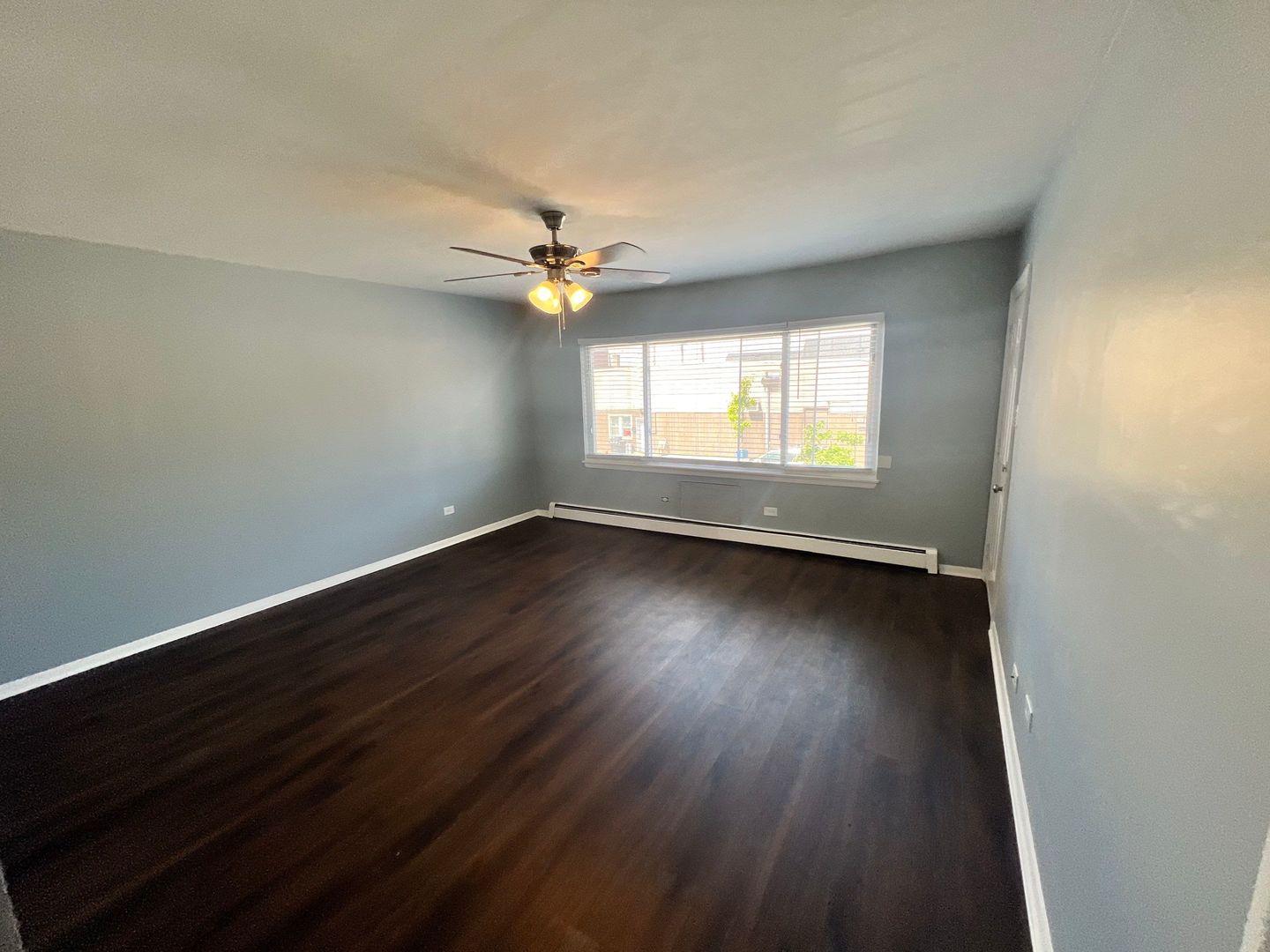 2657 West 47th Street, Unit 6 Chicago, IL 60632 - Photo 6 of 18 an empty room with wooden floor and windows