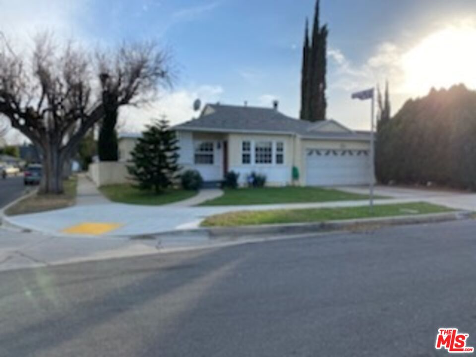 17600 Calvert Street Encino, CA 91316 - Photo 15 of 21 a view of the house with a big yard and large trees