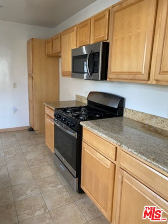 17600 Calvert Street Encino, CA 91316 - Photo 20 of 21 a kitchen with a sink and a stove top oven