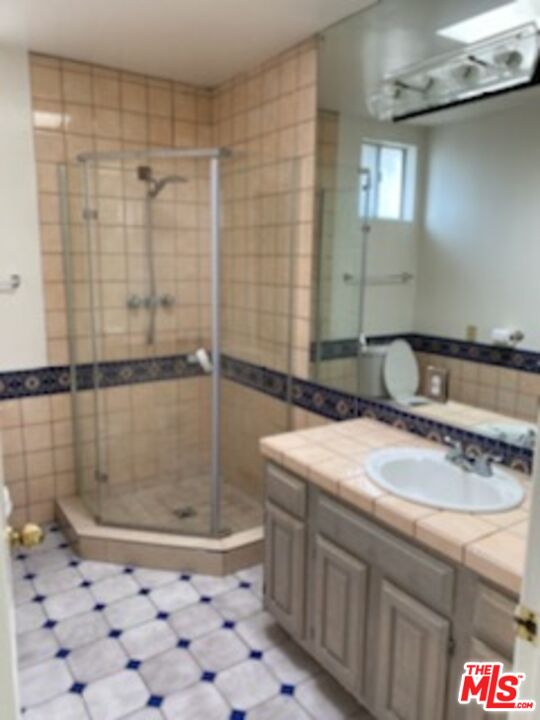 17600 Calvert Street Encino, CA 91316 - Photo 4 of 21 a bathroom with a sink shower and a mirror