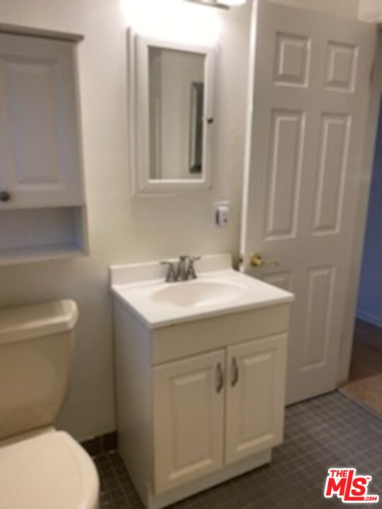 17600 Calvert Street Encino, CA 91316 - Photo 6 of 21 a bathroom with a sink a toilet and a mirror