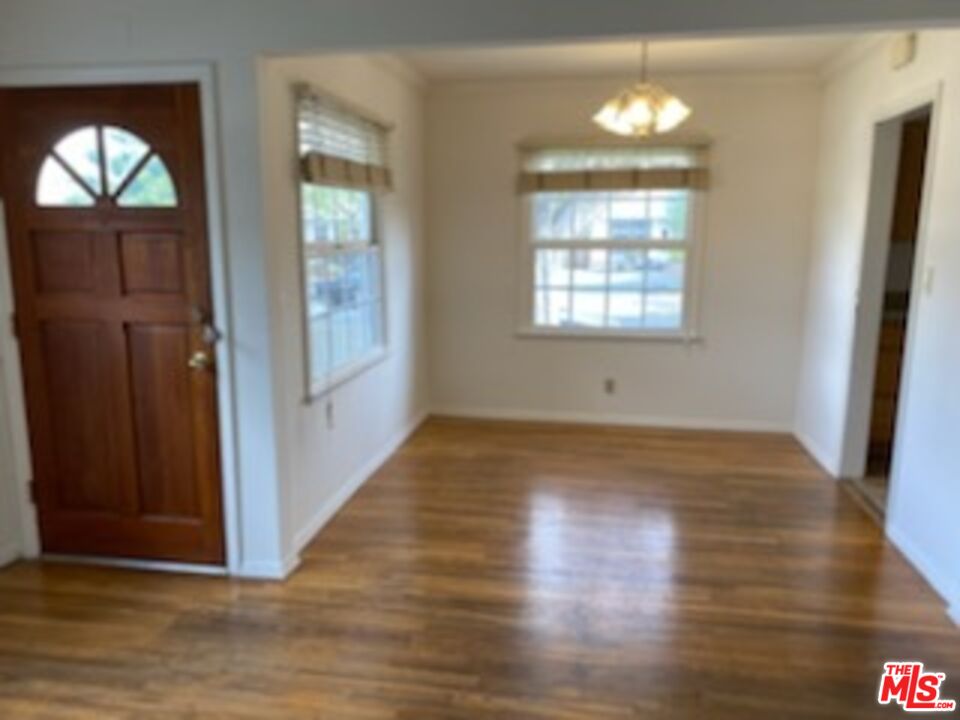 17600 Calvert Street Encino, CA 91316 - Photo 10 of 21 an empty room with wooden floor and windows